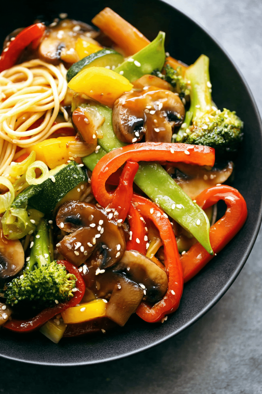 Colorful vegetable stir fry with bell peppers, zucchini, and broccoli served in a bowl.