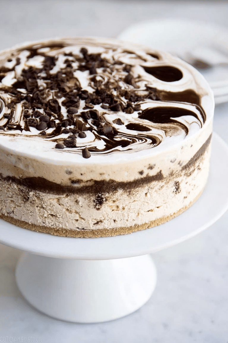 Close-up of a layered coffee ice cream cake with a brownie base, topped with coffee and vanilla ice cream, garnished with chocolate shavings and coffee beans.