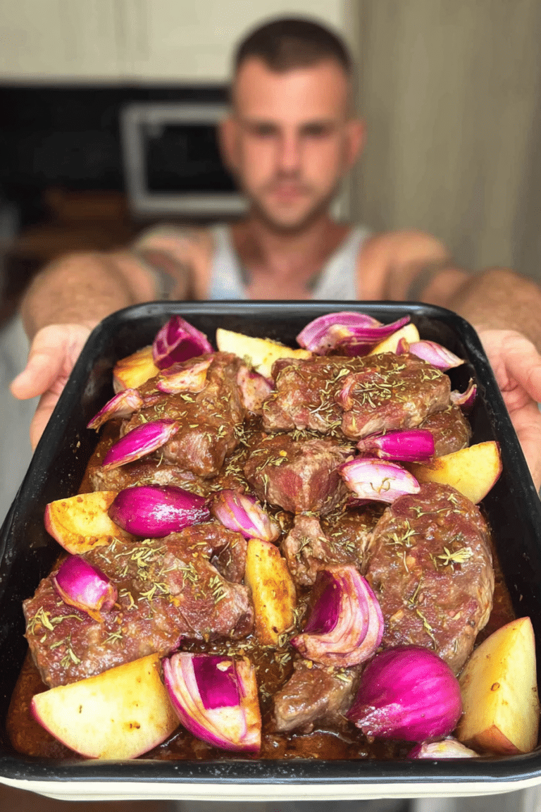 Plated lamb tava with potatoes and herbs in a rustic dish, showcasing the traditional Cypriot meal.