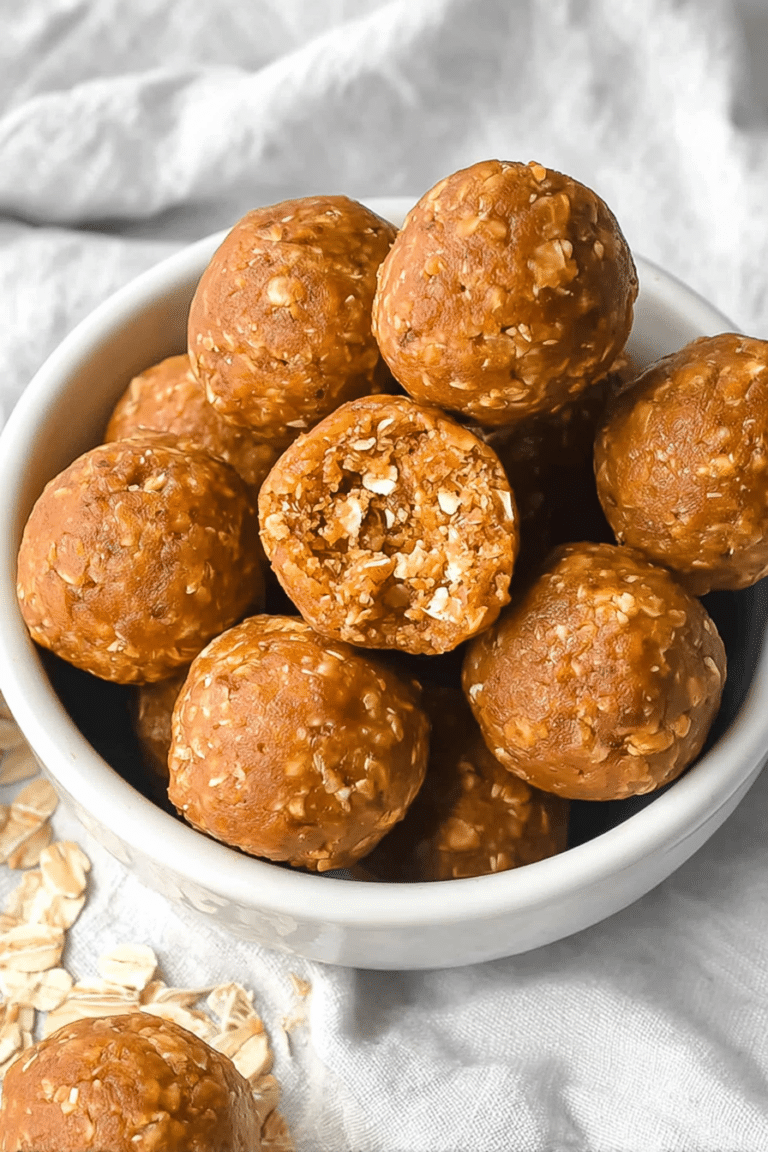 Close-up of healthy no-bake pumpkin protein balls on wooden table with autumn decor.