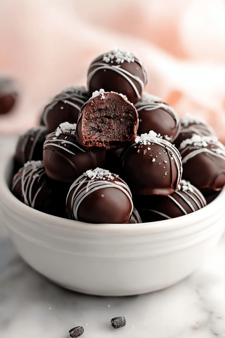 Delicious brownie truffles decorated with colorful sprinkles on a white plate.