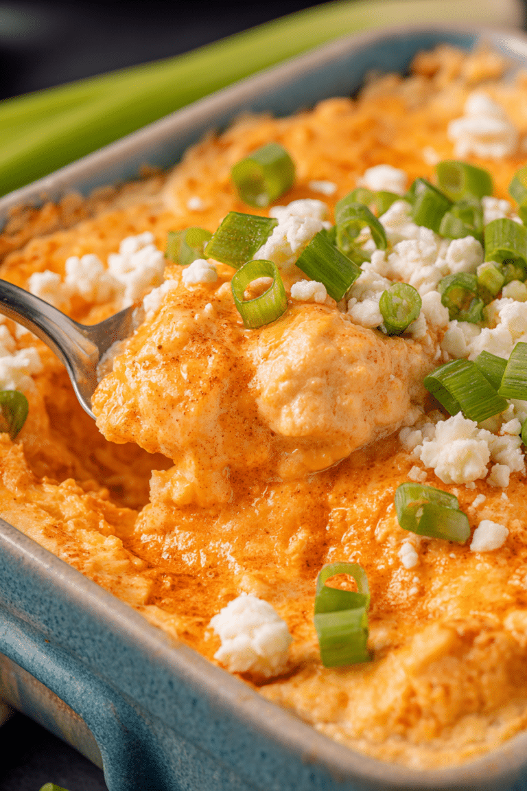 Delicious bowl of Frank's RedHot Buffalo Chicken Dip garnished with green onions, served with tortilla chips.