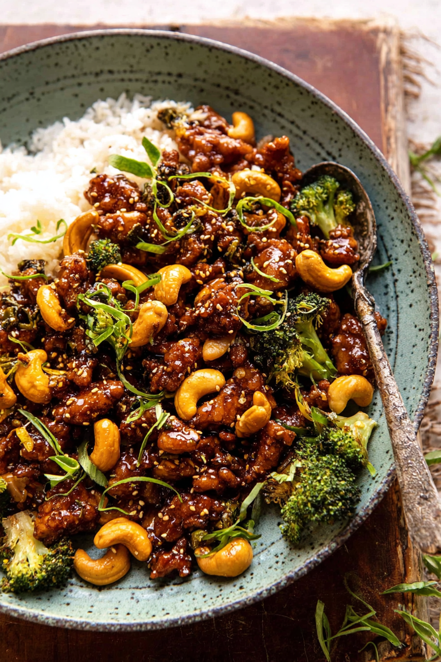 Delicious and quick garlic butter cashew chicken served over rice with green onions and sesame seeds.