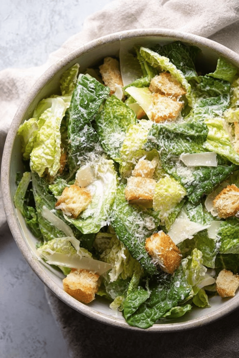Delicious homemade Caesar salad with croutons and Parmesan on a wooden table.