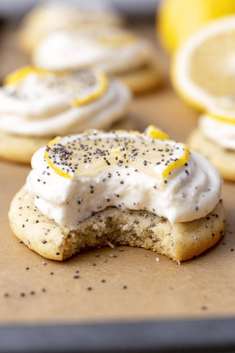 Close-up of lemon poppy seed cheesecake cookies with cream cheese frosting, decorated with lemon slices and poppy seeds.