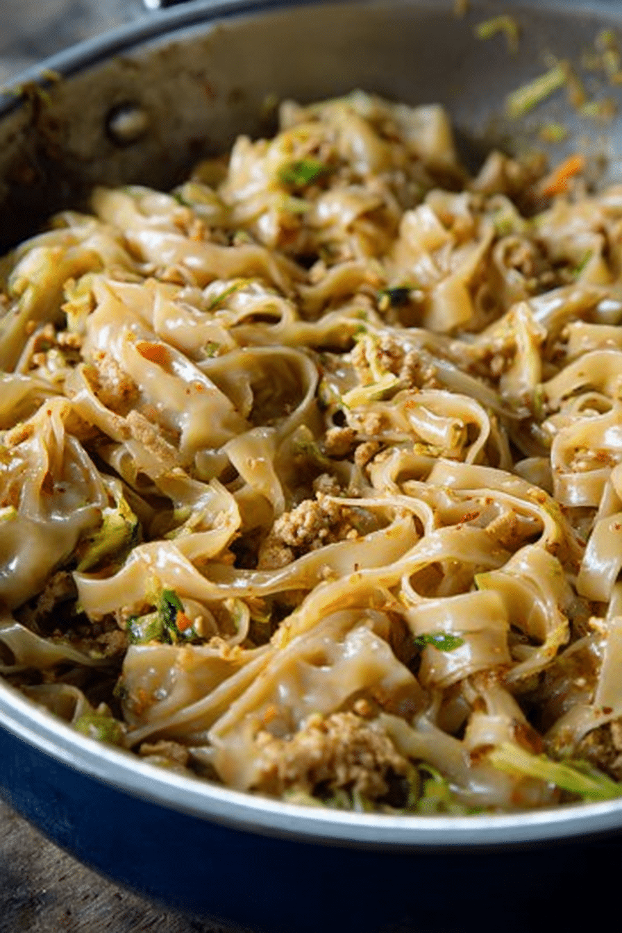 Delicious potsticker noodle bowl with green onions and red pepper flakes