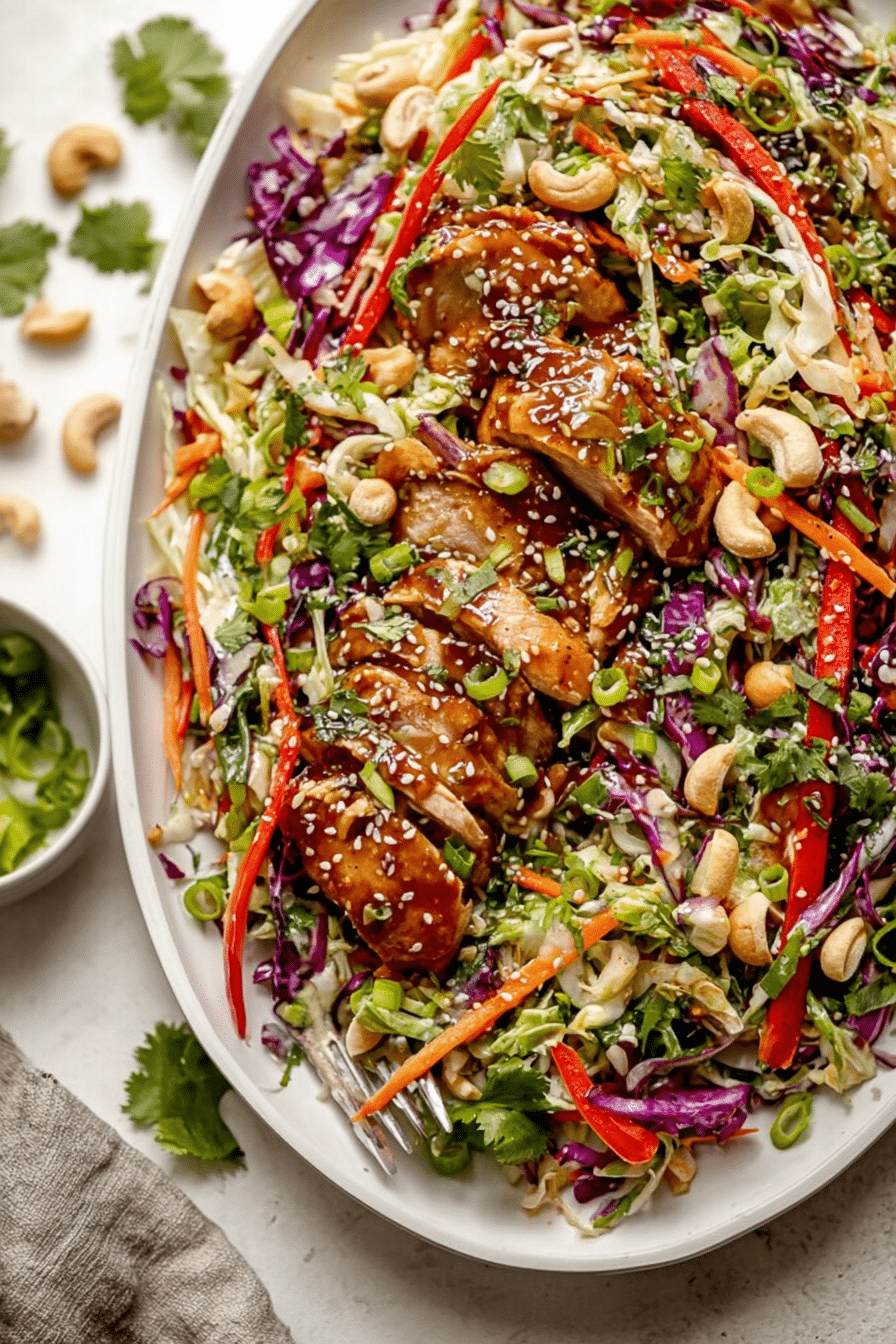 Delicious sesame chicken salad with colorful vegetables, grilled chicken, and sesame seeds in a bowl.