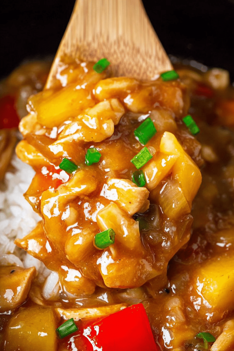 Delicious slow cooker Hawaiian chicken served with rice, garnished with green onions and sesame seeds.