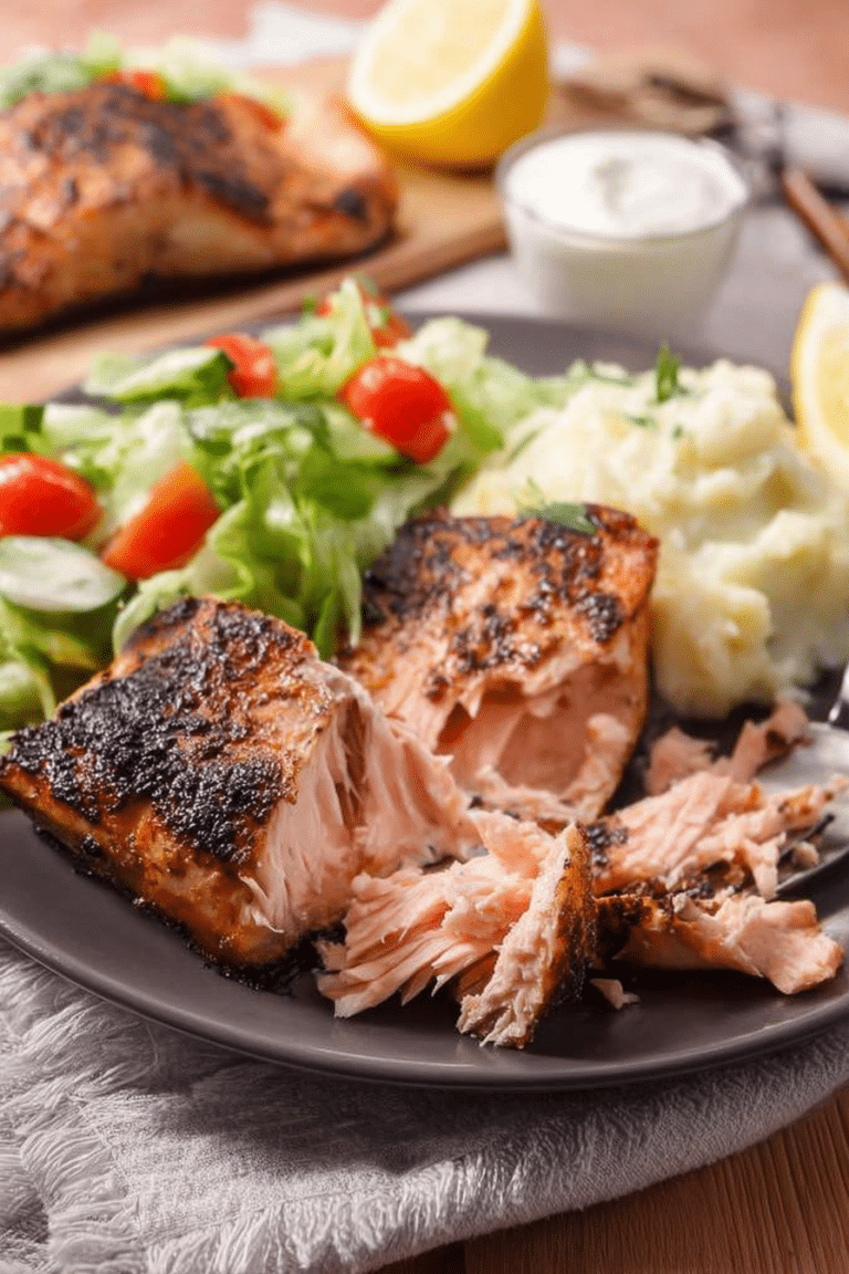 Delicious Texas Roadhouse salmon fillet garnished with lemon and herbs, ready to be served.