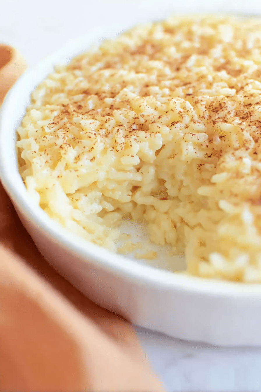 Delicious homemade Portuguese sweet rice pudding in a bowl with cinnamon and lemon zest topping