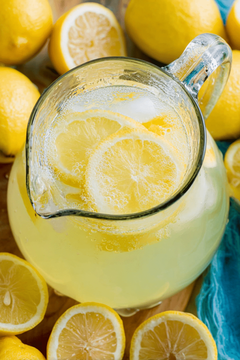 Refreshing homemade lemonade in a glass with ice and lemon slices
