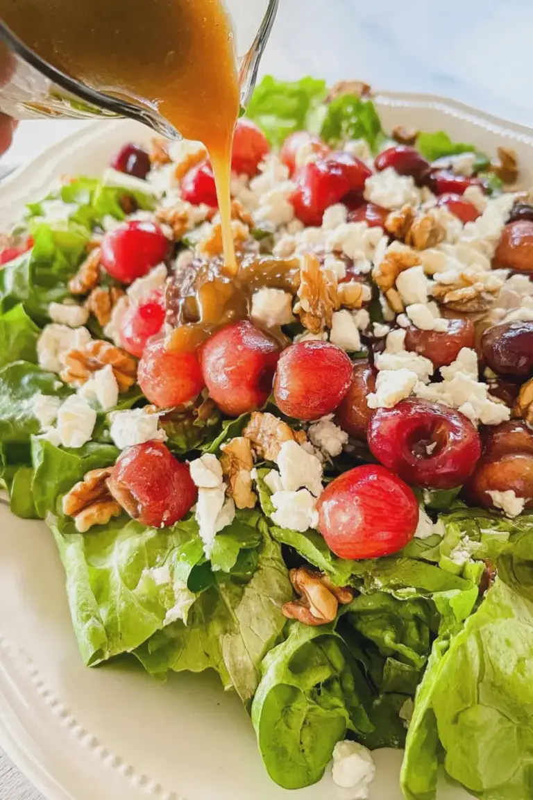 Cherry salad with feta cheese and walnuts on a rustic wooden table, showcasing the vibrant colors of fresh ingredients.