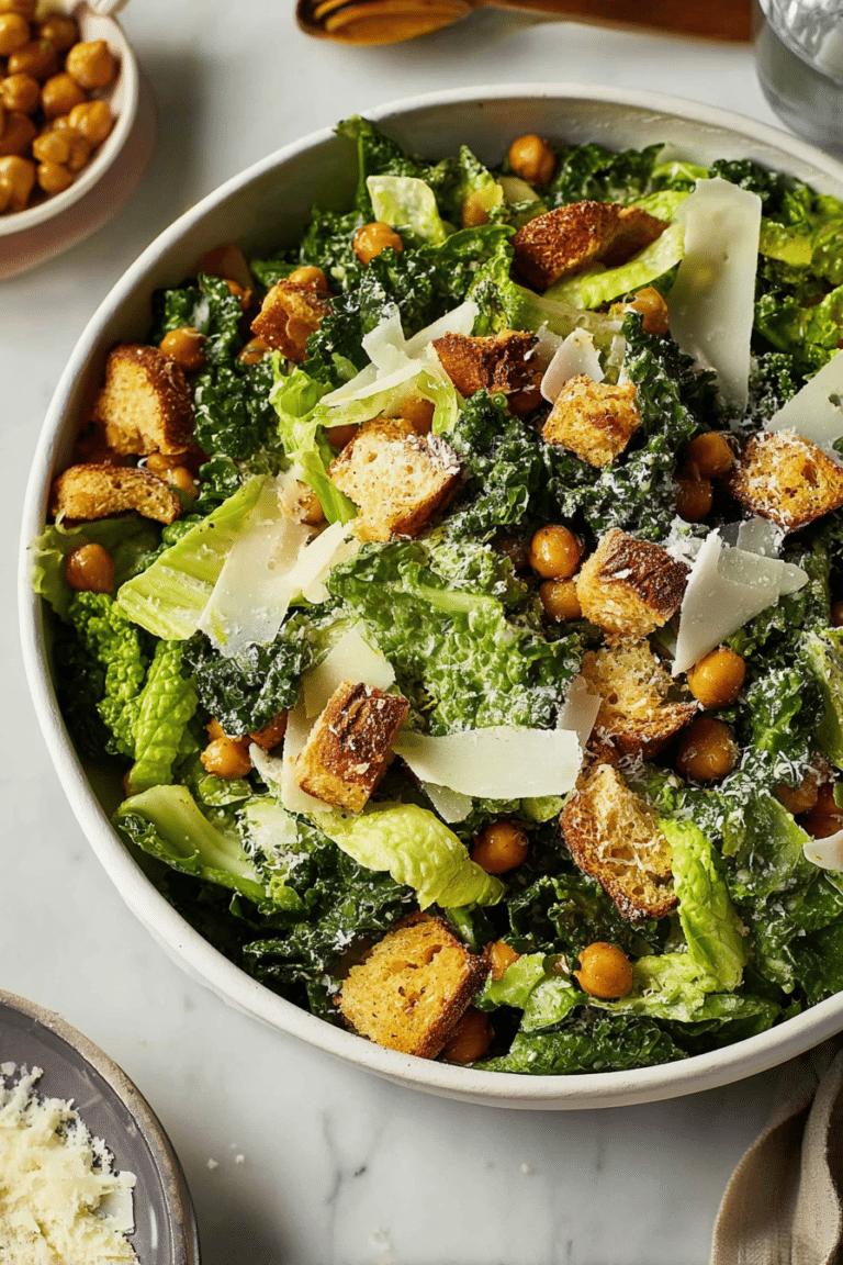 Delicious kale Caesar salad with croutons, Parmesan, and avocado in a wooden bowl
